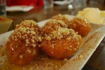 Loukoumades drizzled with nuts and honey