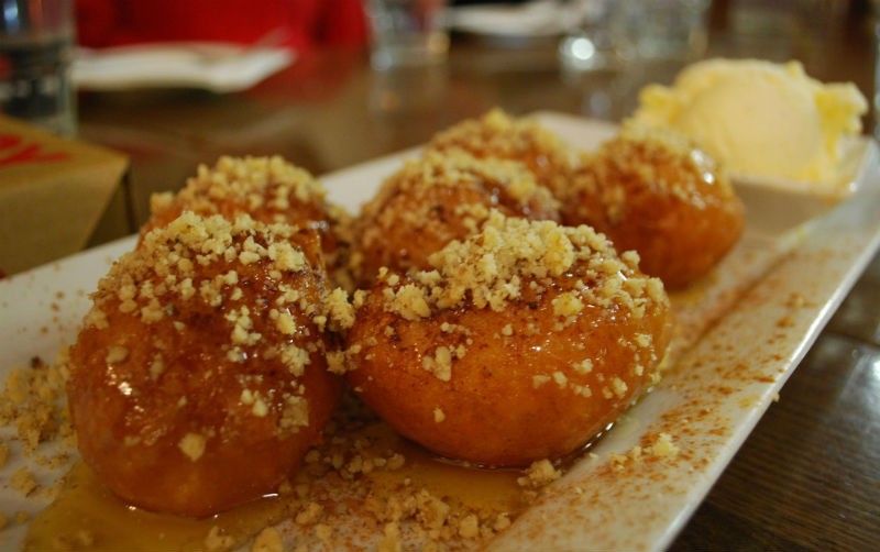 Loukoumades drizzled with nuts and honey