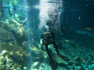 Dos Ojos Cenote Diver Relaxing on his back Bubbles Mexico
