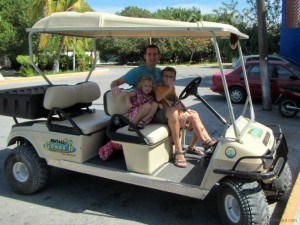 Charles Kosman and kids on a golf cart