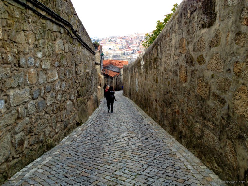 Micki carrying Jordan through the Cobblestone Streets Mom carrying child through the Cobblestone Streets Porto Portugal