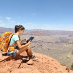 Can I watch Netflix abroad? How a VPN can help. Woman hiking with tablet.