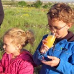 Kids celebrating with a glass of oj