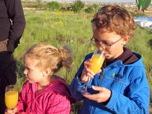 Kids celebrating with a glass of oj