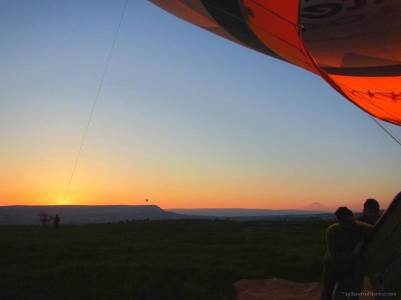 Setting the hot air balloon basket upright at sunrise Goreme Butterfly Balloons