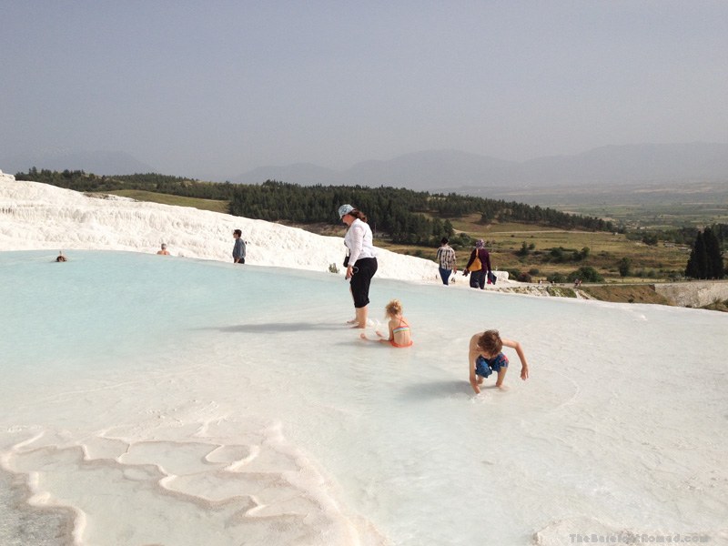 The Barefoot Nomad family playing in the natural hot water springs of Pamukkale, Turkey
