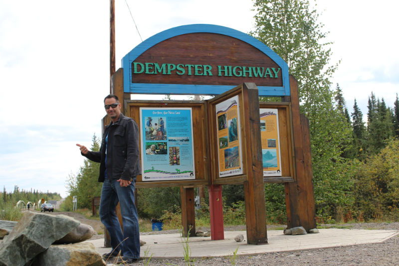 Ryan Deacon posing in front of the Dempster Highway