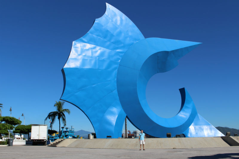 Charles Kosman in front of giant blue sailfish in Manzanillo, Mexico