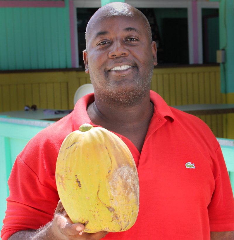 Anguilla Aclan offering up a coconut fresh from the tree