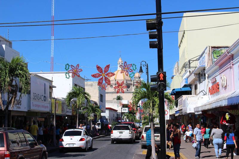 People and cars on the clean streets of Colima