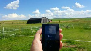 Tep Wireless working on a farm with barn in background