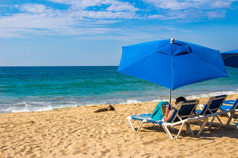 Beach and woman on sun lounger San Pancho Mexico Riviera Nayarit