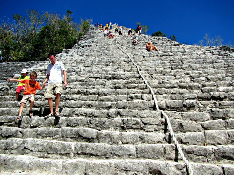 Dad and son descending the pyramid at Coba Mexico