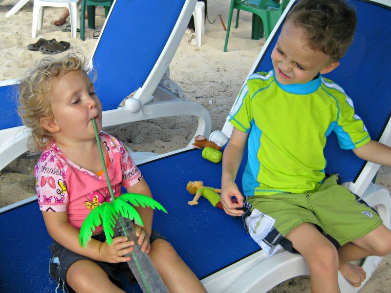 Kids enjoying an oversized drink in Cozumel at Carlos And Charlies