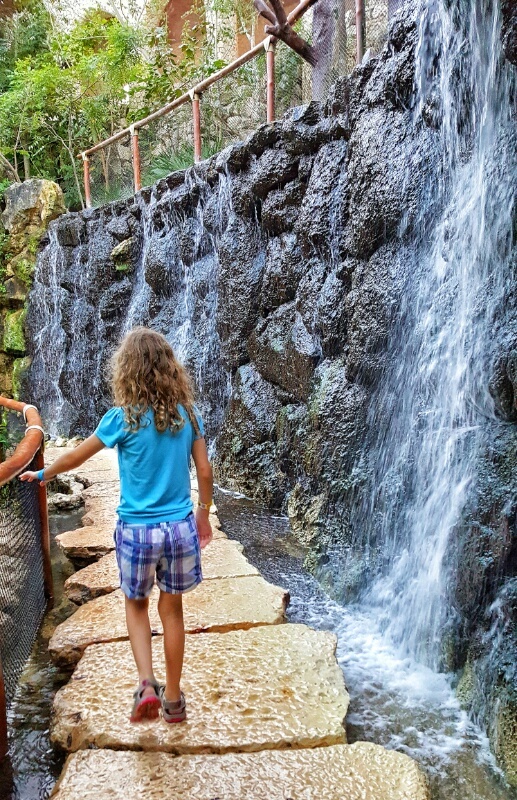 Xcaret girl at waterfall in aviary