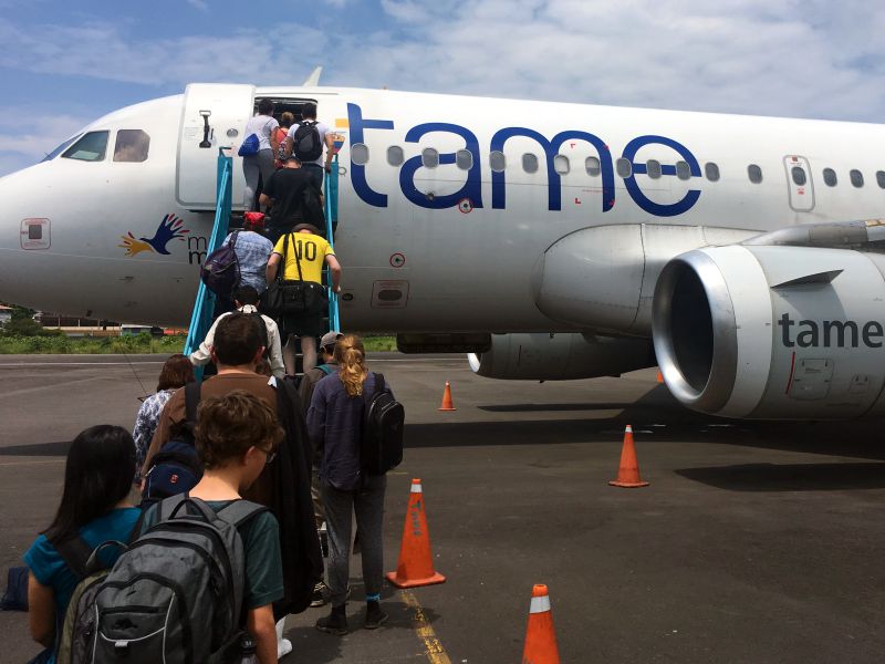 flight attendant supervising boarding Tame Flight from Coca to Quito