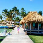 Girl running down the dock at Victoria House Belize