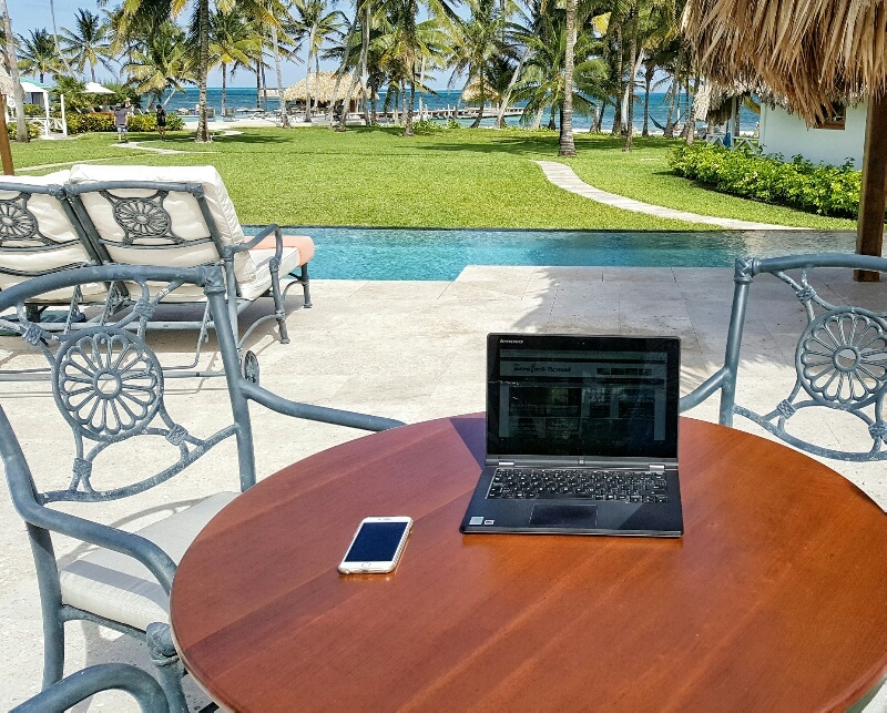 Laptop by pool and ocean Victoria House Belize
