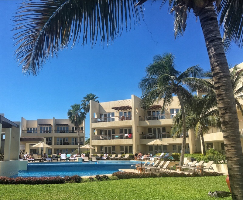 View of pool and codos outside The Phoenix Belize Resort