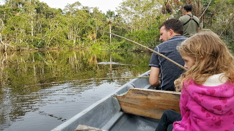 Dad and daughter fishing for piranha in the Amazon