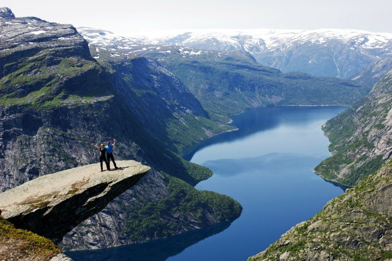 Couple on top of Trolls Tongue Trolltunga in Norway DP