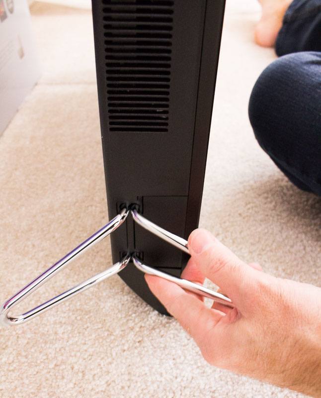 Installing the metal foot stand on the bottom of the VIZIO TV