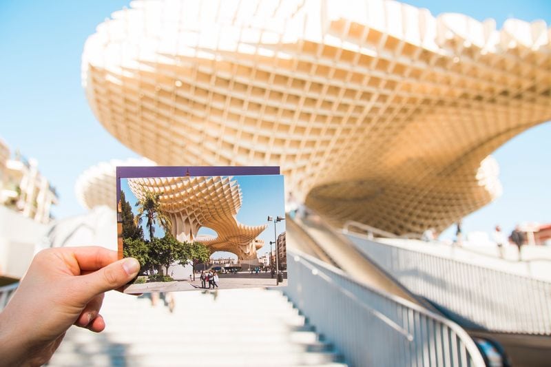 photo held up in front of tourist landmark for ways to preserve your travel memories