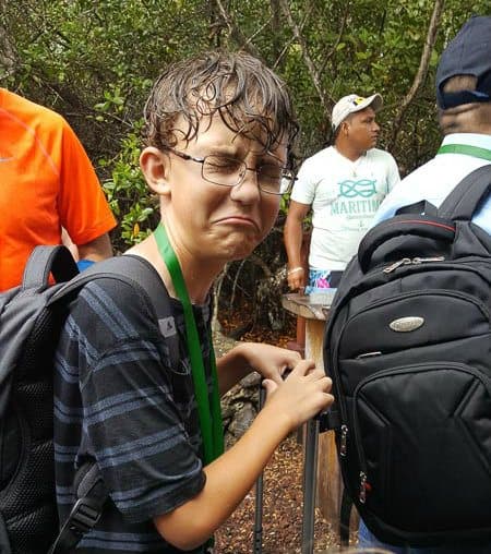 soaked to the skin in the rain waiting for a ferry on Isabela Island in the Galapagos