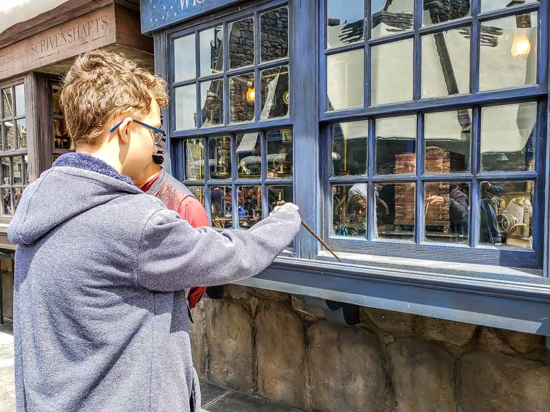 Teen using wand at Universal Studios Hollywood