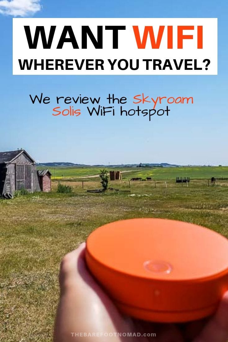 Skyroam Solis portable WiFi in prairie field with barn in background