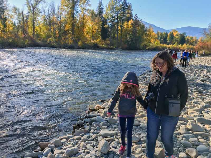 mom and daughter walking along Adams River riverbank in British Columbia during the Sockeye salmon run 