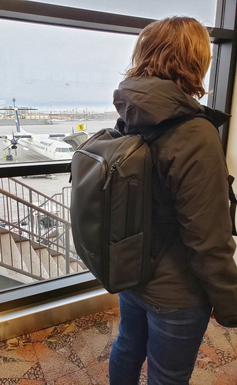 Nomatic backpack on woman airport