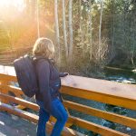 woman with a backpack on a bridge