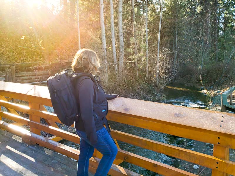 woman with a backpack on a bridge