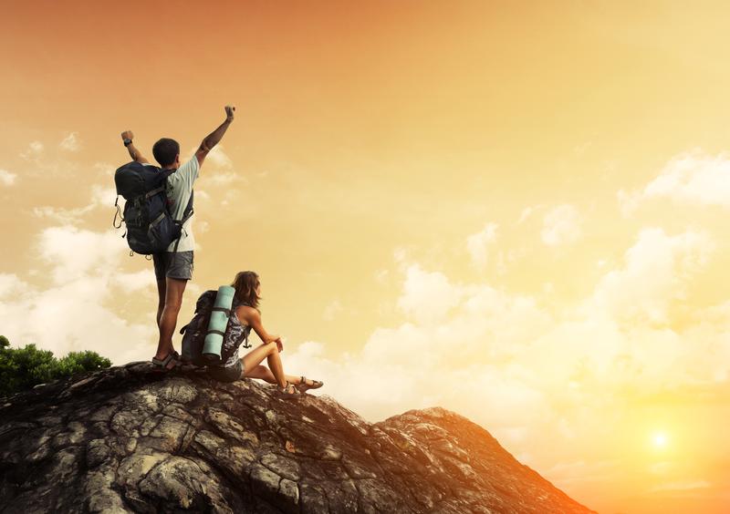 hikers on top of mountain at sunset