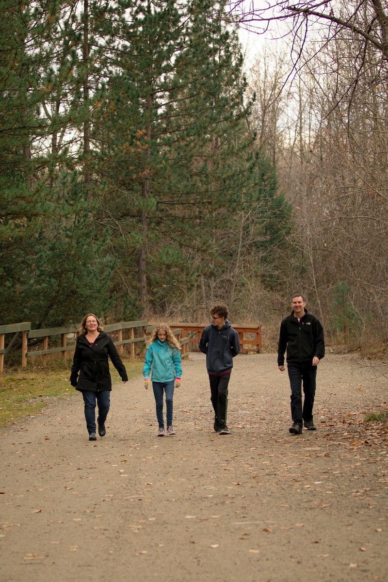 Family walking in Mission Creek Kelowna British Columbia 