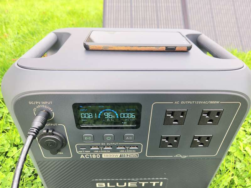 BLUETTI AC180 charged by BLUETTI PV350 solar panel charging phone and being charged in clouding conditions