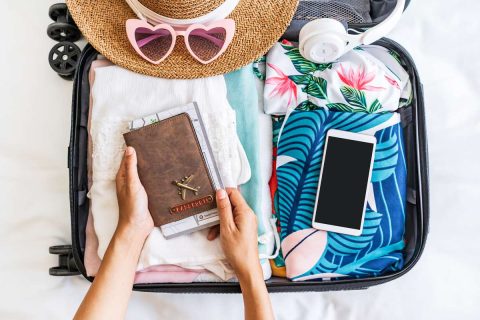 Maya eSIM review - photo of traveler holding passport suitcase luggage