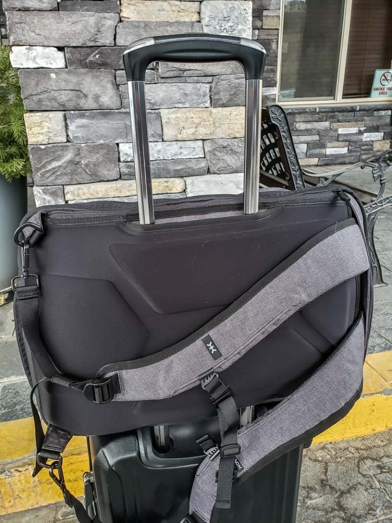 Knack backpack hidden sleeve that slips over a suitcase handle