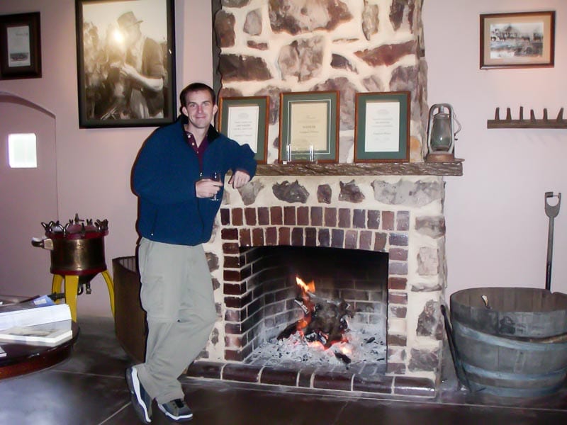 By the fireplace at Front door of Wolf Blass Winery Australia with winemaking equipment nearby