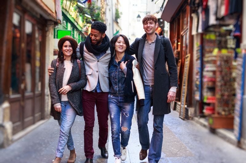 friends having fun in Paris Latin Quarter, near Notre Dame Cathedral.