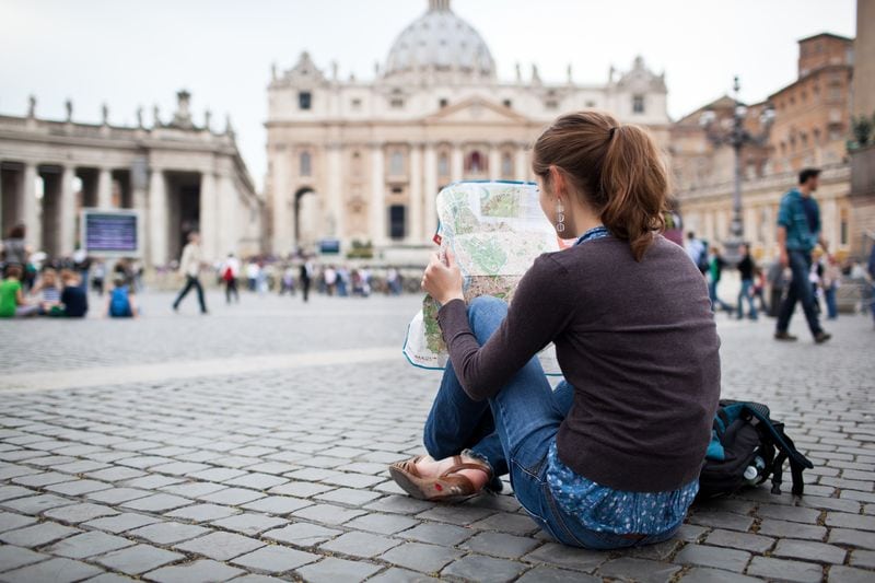 Tourists studying maps in St. Peter's Square