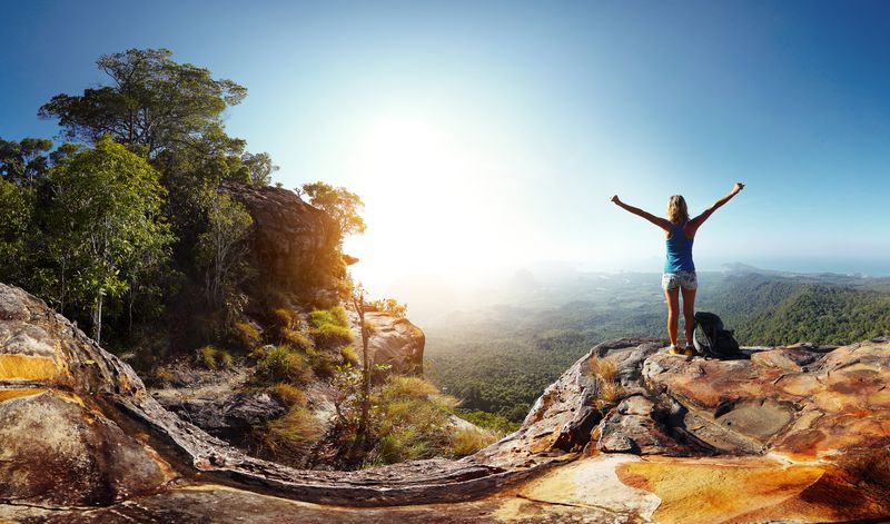 women hiking to top of mountain