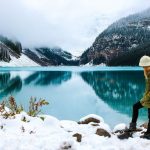 best travel vloggers on Youtube woman in front of Canadian lake in winter