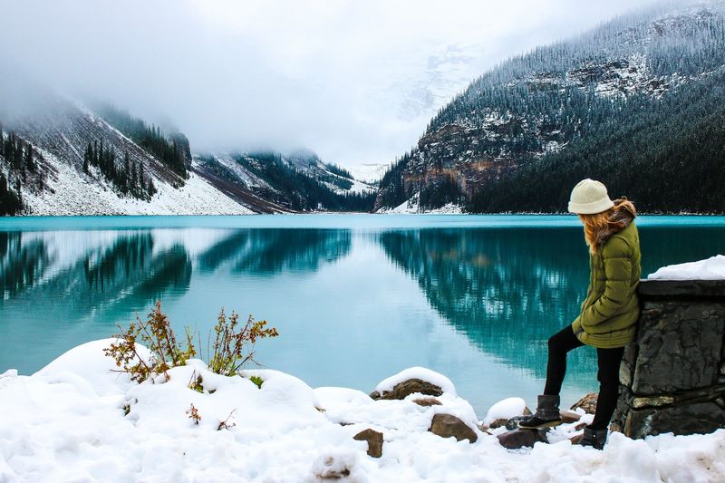 woman in front of Canadian lake in winter