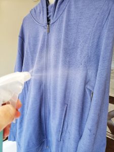 Spraying Unbound Merino with water to reduce wrinkles
