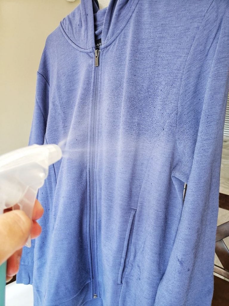 Spraying Unbound Merino with water to reduce wrinkles 