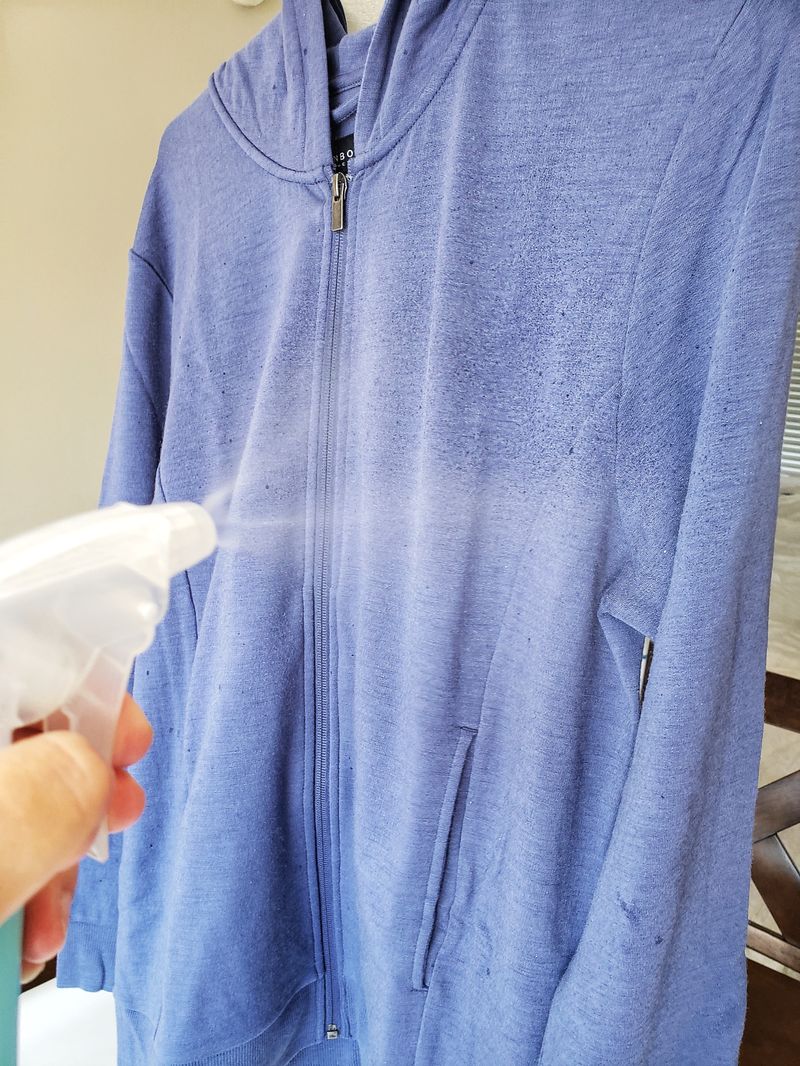 Spraying Unbound Merino with water to reduce wrinkles