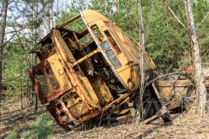 Rusted overturned school bus in Pripyat Ukraine