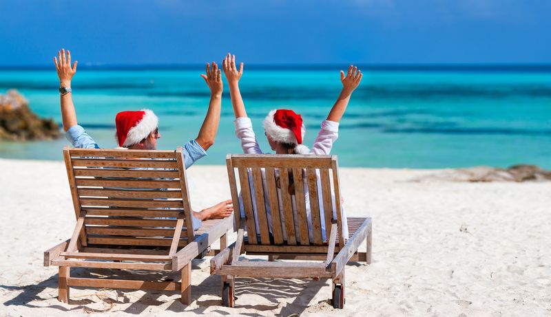 Couple on the beach in Santa Hats